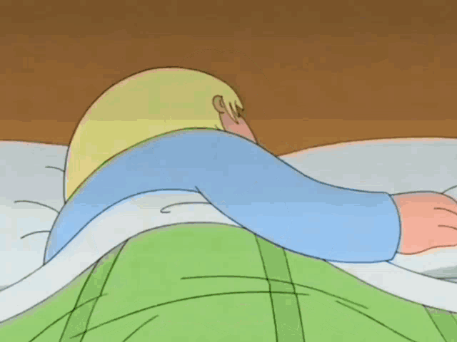 a cartoon character is laying in a bed with the words aaeaaa written on the bottom
