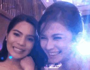 two women are posing for a picture and smiling at the camera