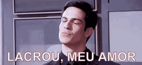 a man in a suit and tie is making a funny face with his eyes closed and the words lacrou meu amor .