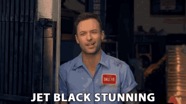a man wearing a blue shirt with a dallas patch on his chest says jet black stunning
