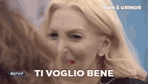 a close up of a woman 's face with the words ti voglio bene written on it .