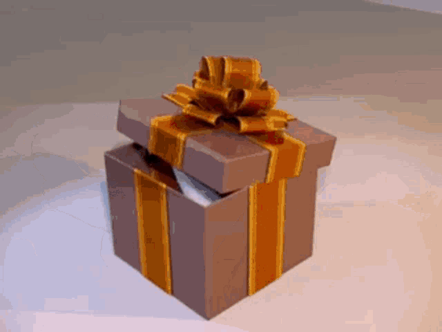 a brown gift box with a gold striped ribbon and bow