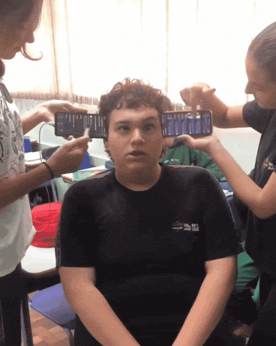 a boy wearing a black shirt that says ' sol est ' on the front