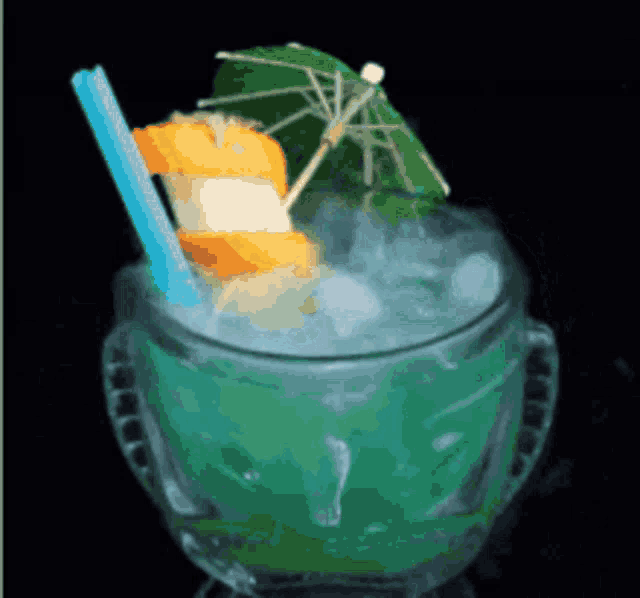 a green drink with a blue straw and a green umbrella