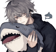 a boy is holding a stuffed shark with a fish in the background