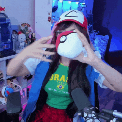 a woman in a rio de janeiro shirt holds a pokeball in front of her face
