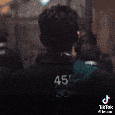 a man wearing a red vest with the number 456 on it