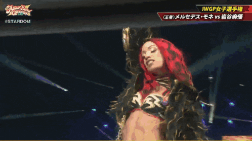 a woman in a red head scarf is standing next to another woman in a gold outfit with the words stardom on the bottom