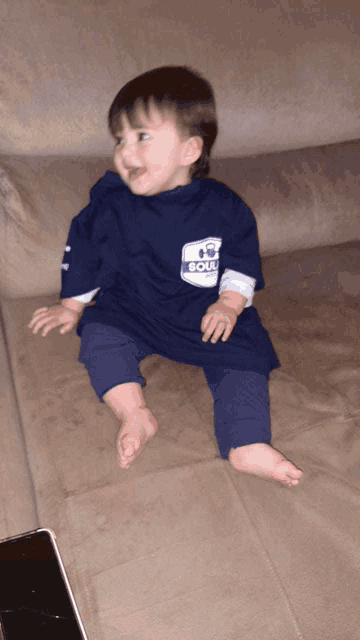 a baby wearing a blue shirt that says soul on it