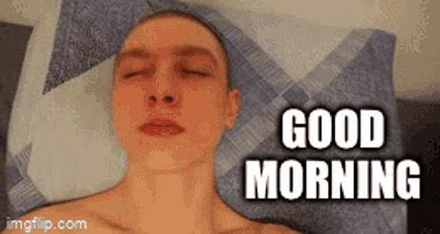a man laying on a bed with his eyes closed and the words good morning written above him