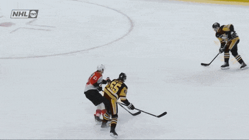 a hockey game is being played in front of a lumber ad