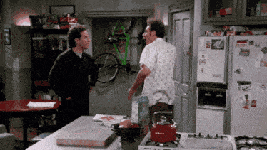 two men standing in a kitchen with a fridge that says ' earl ' on it