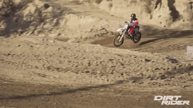 a dirt rider is riding a dirt bike