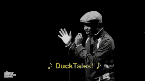 a man singing into a microphone with the words ducktales o-o-o-o on the bottom