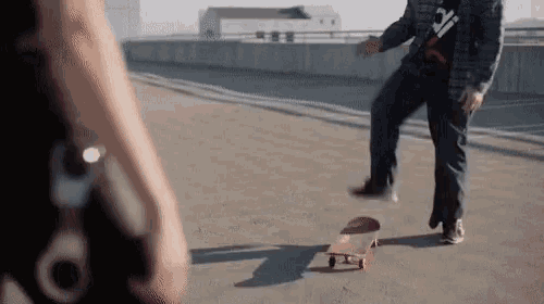 a person standing next to a skateboard with a wrench on their hand