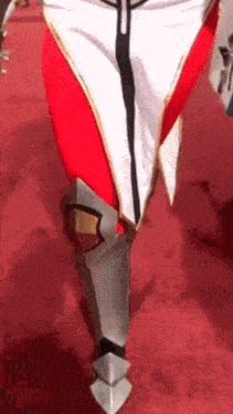 a person wearing a costume is walking on a red carpet .