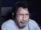 a man wearing headphones is making a funny face .