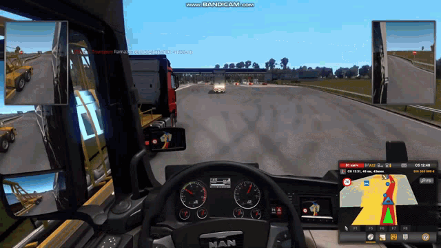 a man truck is driving down a road in a game