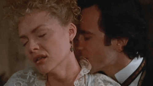 a man kissing a woman on the neck in a movie