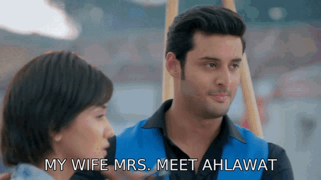 a man and a woman are looking at each other and the man says " my wife mrs. meet alhawat "