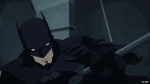 a man in a batman costume is holding a pole in his right hand