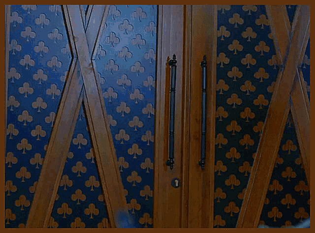 a door with a pattern of clubs on the wall behind it