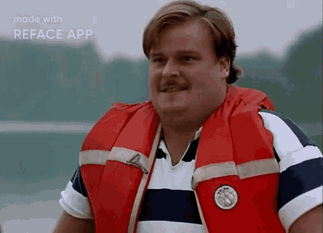 a man is wearing a life jacket and a striped shirt ..