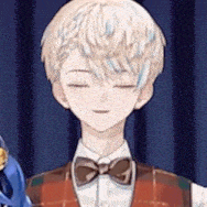 a boy wearing a vest and bow tie is holding a pair of scissors .