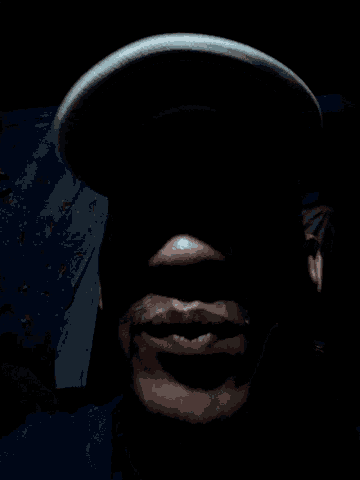 a close up of a person 's face in the dark