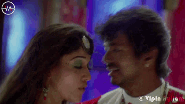 a man and a woman are kissing in a video which is sponsored by vipin music