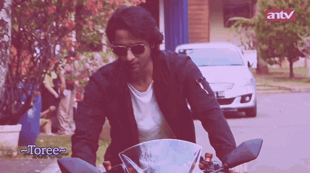 a man riding a motorcycle with the name toree on the bottom