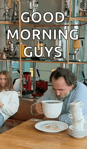 a man is sitting at a table drinking a cup of coffee with the words good morning guys written above him