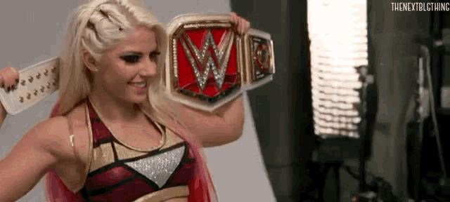 a woman in a wrestling outfit is holding a wwe championship belt .