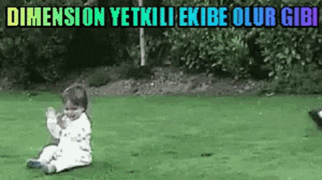 a baby is sitting on the grass in front of a sign that says dimension yetkili ekibe olur giri .
