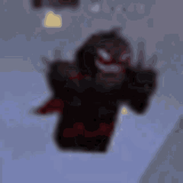 a blurred image of a monster in a video game flying through the air .