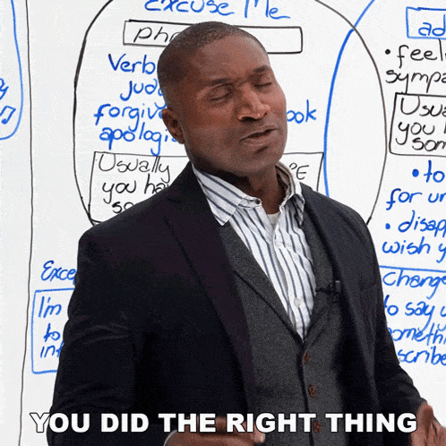a man in a suit stands in front of a white board and says you did the right thing