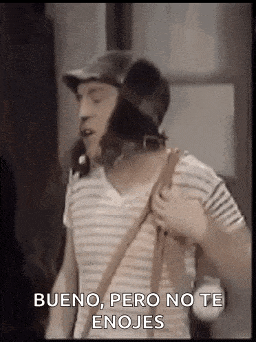 a man wearing a helmet and a striped shirt is holding a purse and talking .
