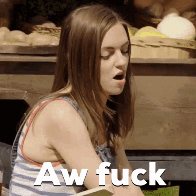 a woman sitting at a table with aw fuck written on the bottom