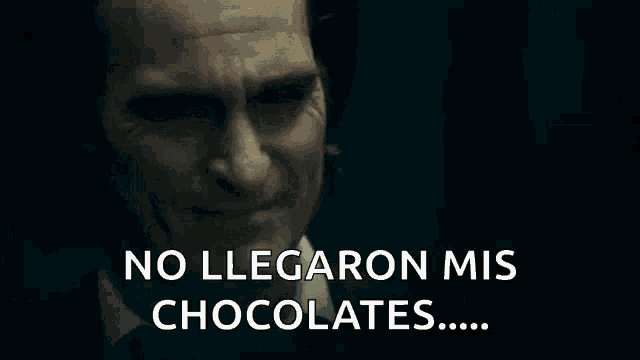a close up of a man 's face with the words `` no llegaron mis chocolates '' written on it .