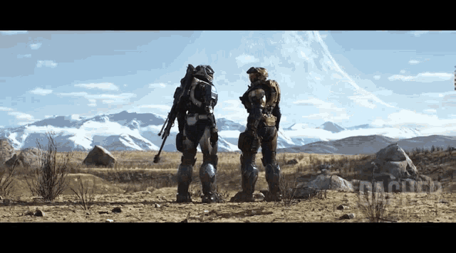 two soldiers standing in a desert with mountains in the background and the word halo on the bottom