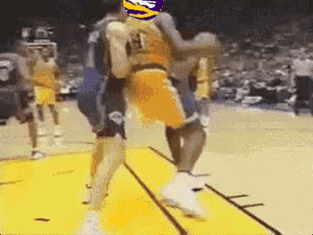 a basketball player wearing a number 1 jersey is being lifted by another player
