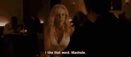 a woman in a white dress is talking to a man in a dark room and says " i like that word manhole "