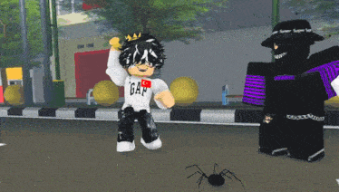 a boy in a gap shirt stands next to a black spider