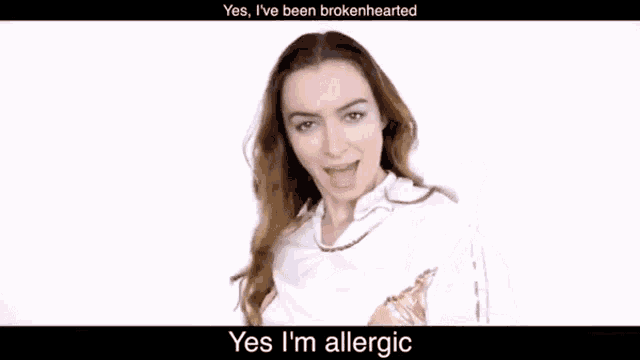 a woman in a white shirt is holding a yellow item and says yes i 'm allergic