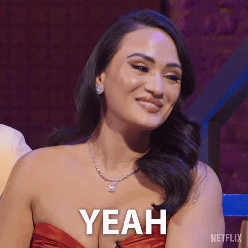 a woman in a red dress is smiling with the word yeah above her