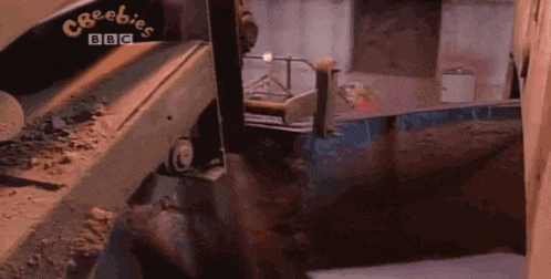 a bbc logo is on a machine that is cutting a piece of wood .