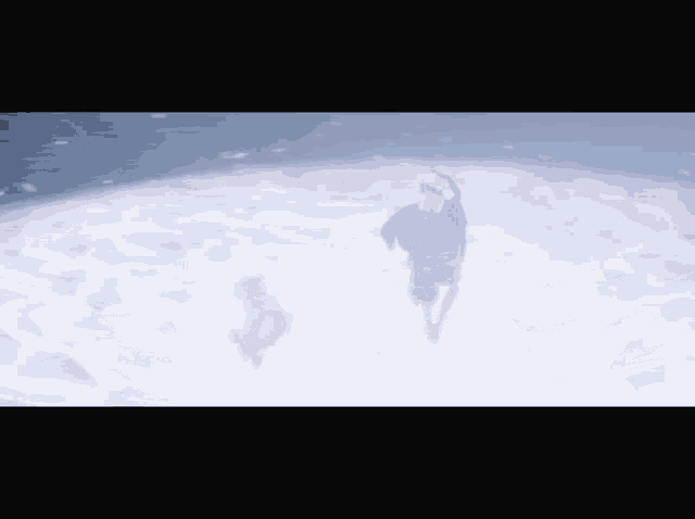 a man and a woman are standing in a circle in the snow
