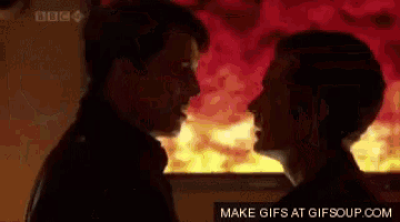a couple kissing in front of a screen that says " make gifs at gifsoup.com "