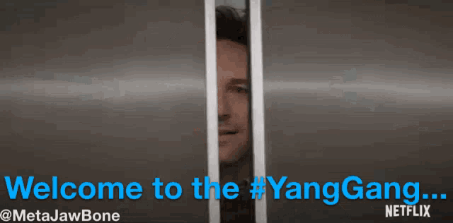 a man behind bars with the words welcome to the #yanggang written below him