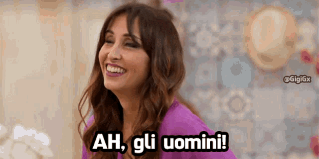 a woman in a purple shirt is laughing and saying ah gli uomini